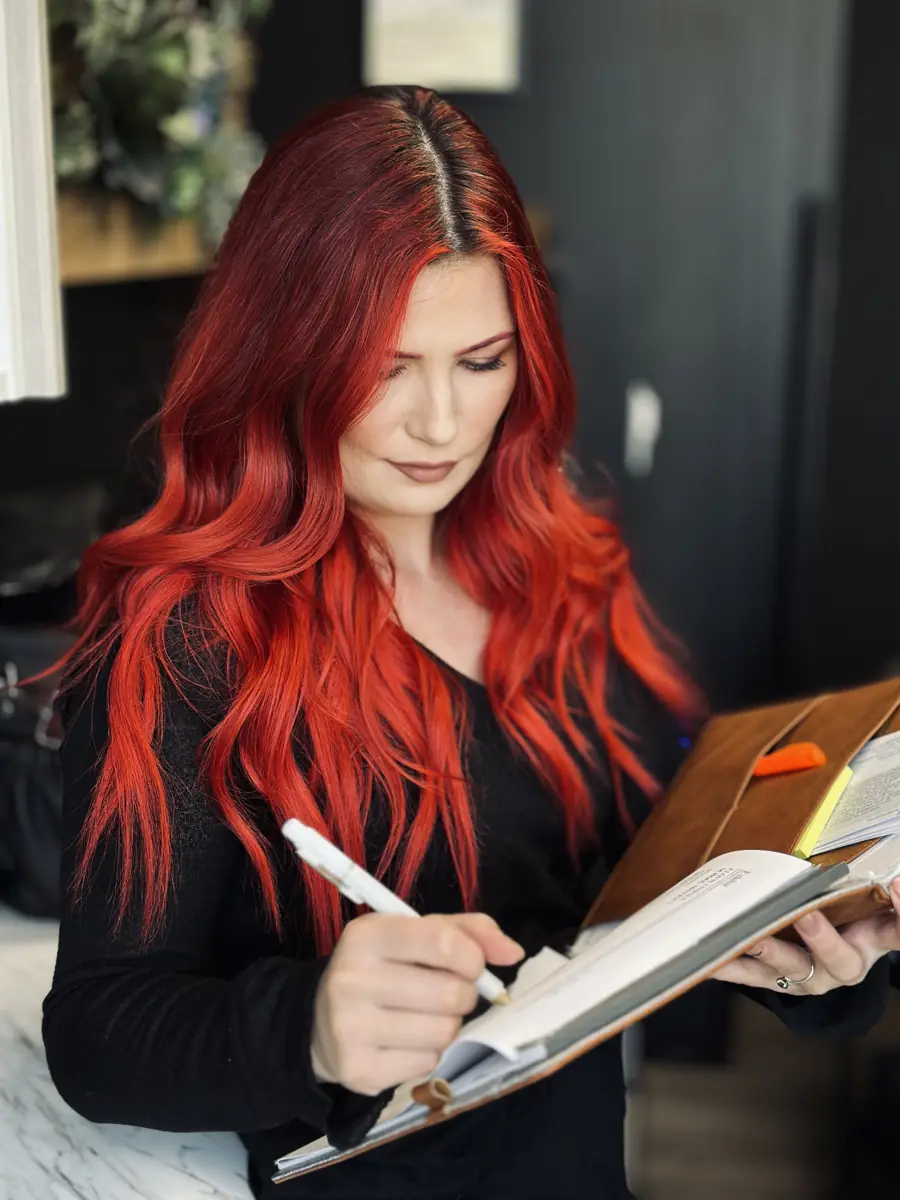 Timillia planning a client's hair extension game plan in her Clovis studio