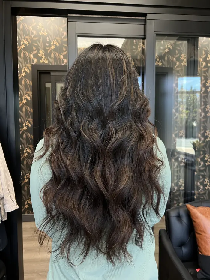 Hand-tied hair extensions on long brunette hair, Clovis CA
