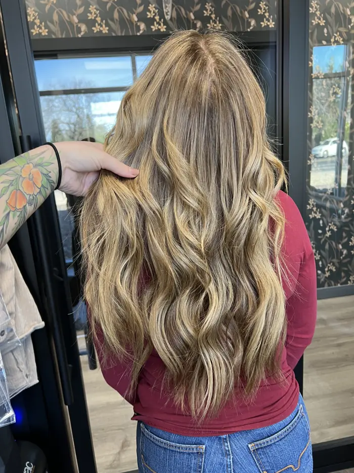 Honey blonde extensions styled in soft curls, Clovis CA